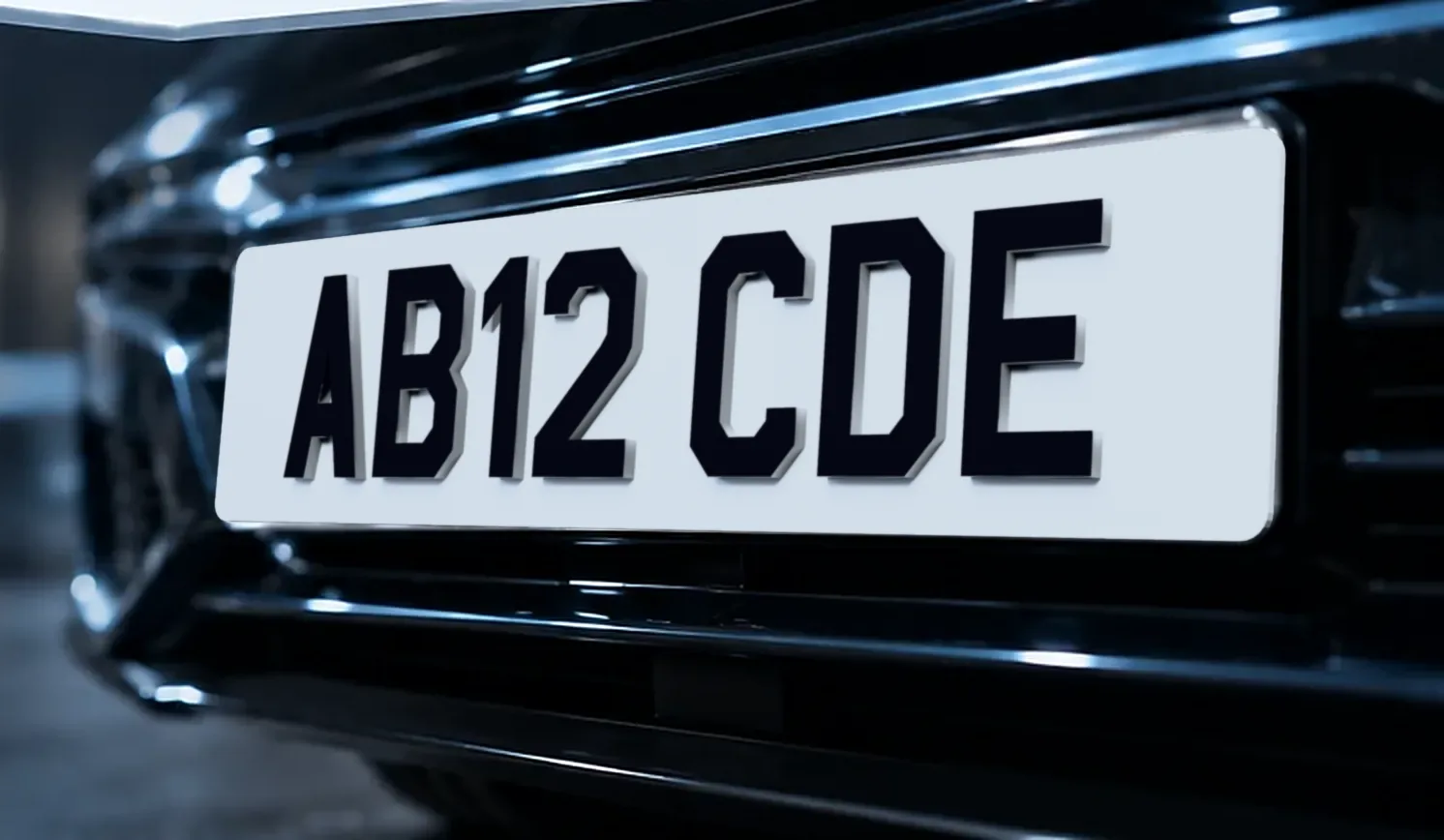 The front of a dark car fitted with a white 4D number plate