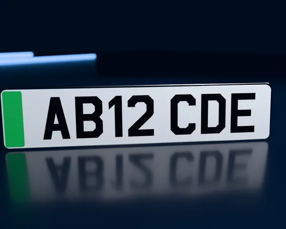A white number plate with a green flash at the left, reading AB12 CDE