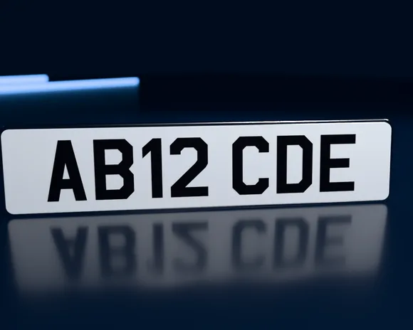 A road-legal white number plate reading AB12 CDE