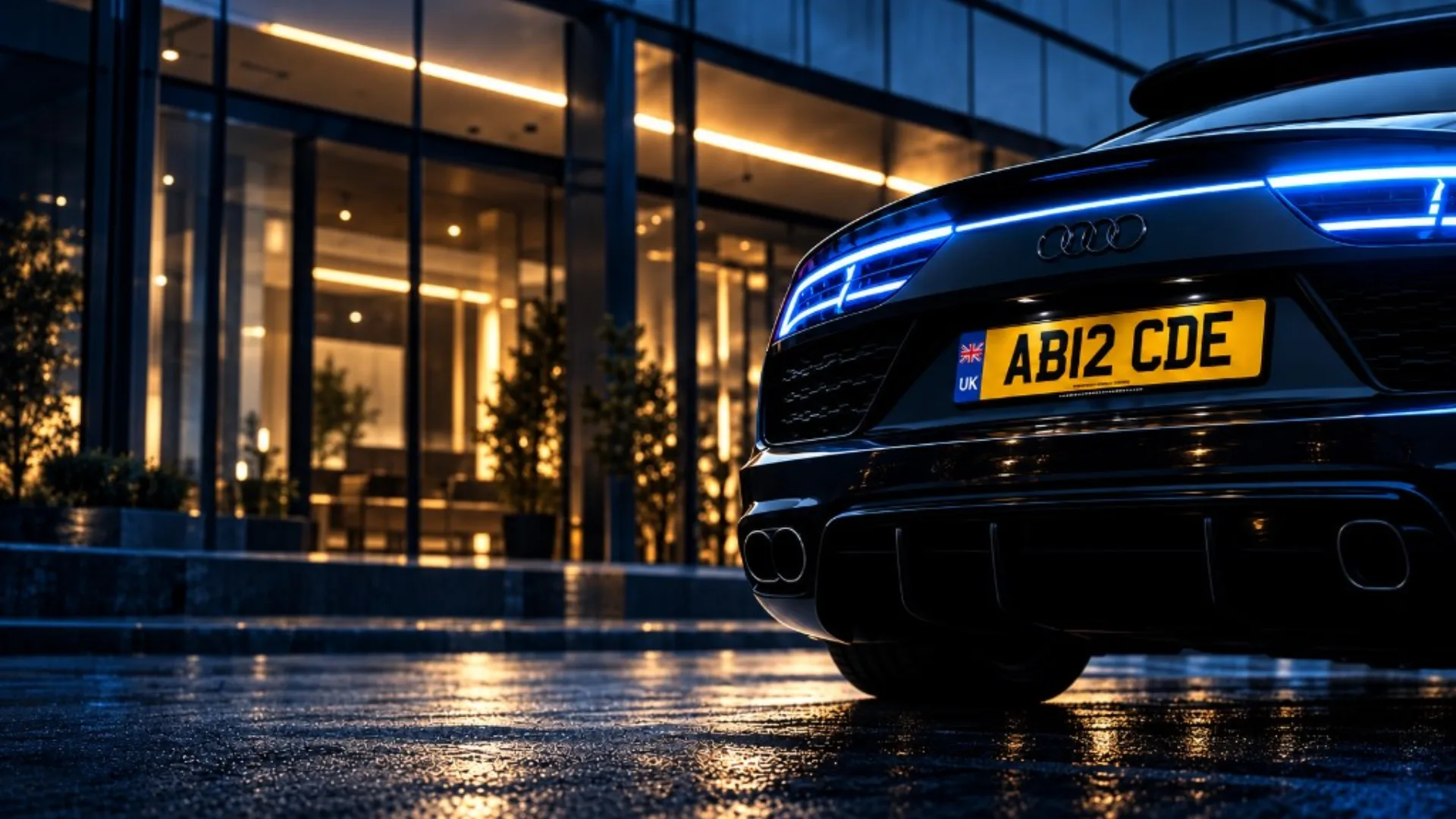 Black car at night with a yellow UK number plate